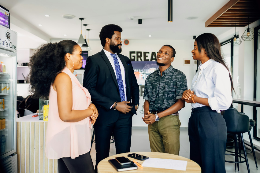A group of people standing around a table